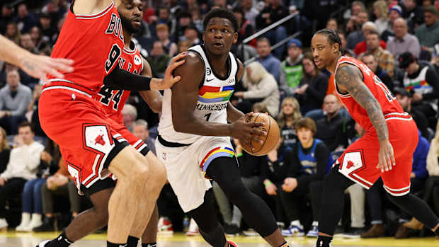 Dec 18, 2022; Minneapolis, Minnesota, USA; Minnesota Timberwolves guard Anthony Edwards (1) dribbles while Chicago Bulls center Nikola Vucevic (9) defends